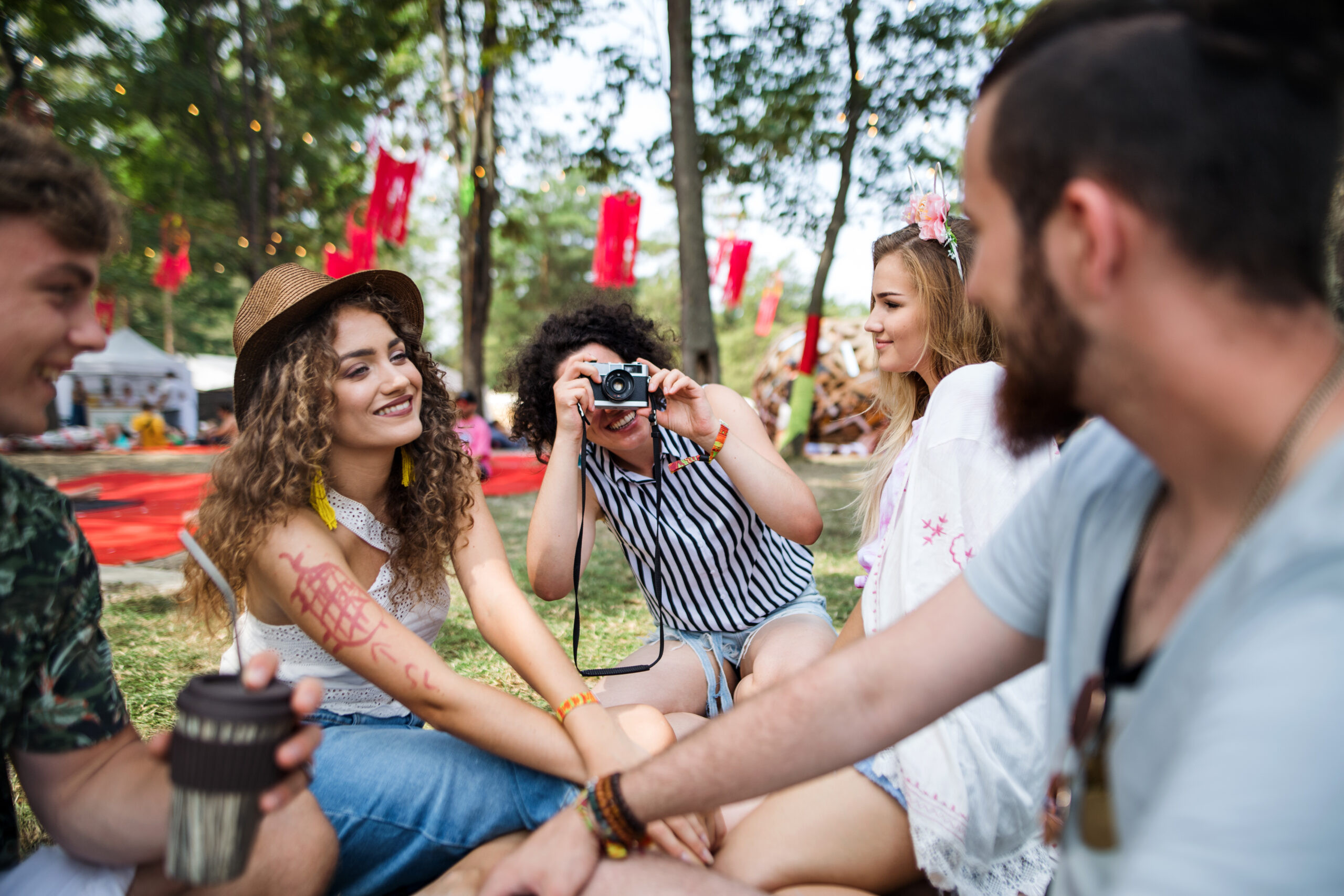 group-of-young-friends-sitting-on-ground-at-summer-2023-11-27-05-31-53-utc-scaled_main