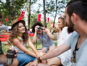 group-of-young-friends-sitting-on-ground-at-summer-2023-11-27-05-31-53-utc-scaled_main